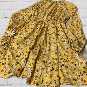 Floral dress size M. Knee length. Long sleeves with hand ties. Cool material.